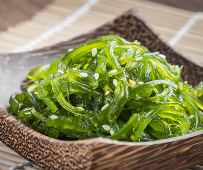 A bowl of green seaweed salad