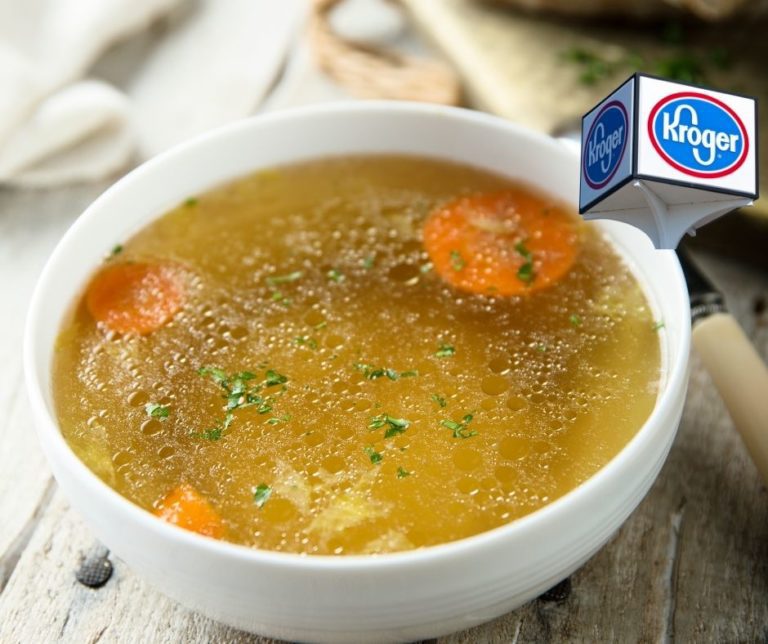 A bowl of chicken broth with vegetables