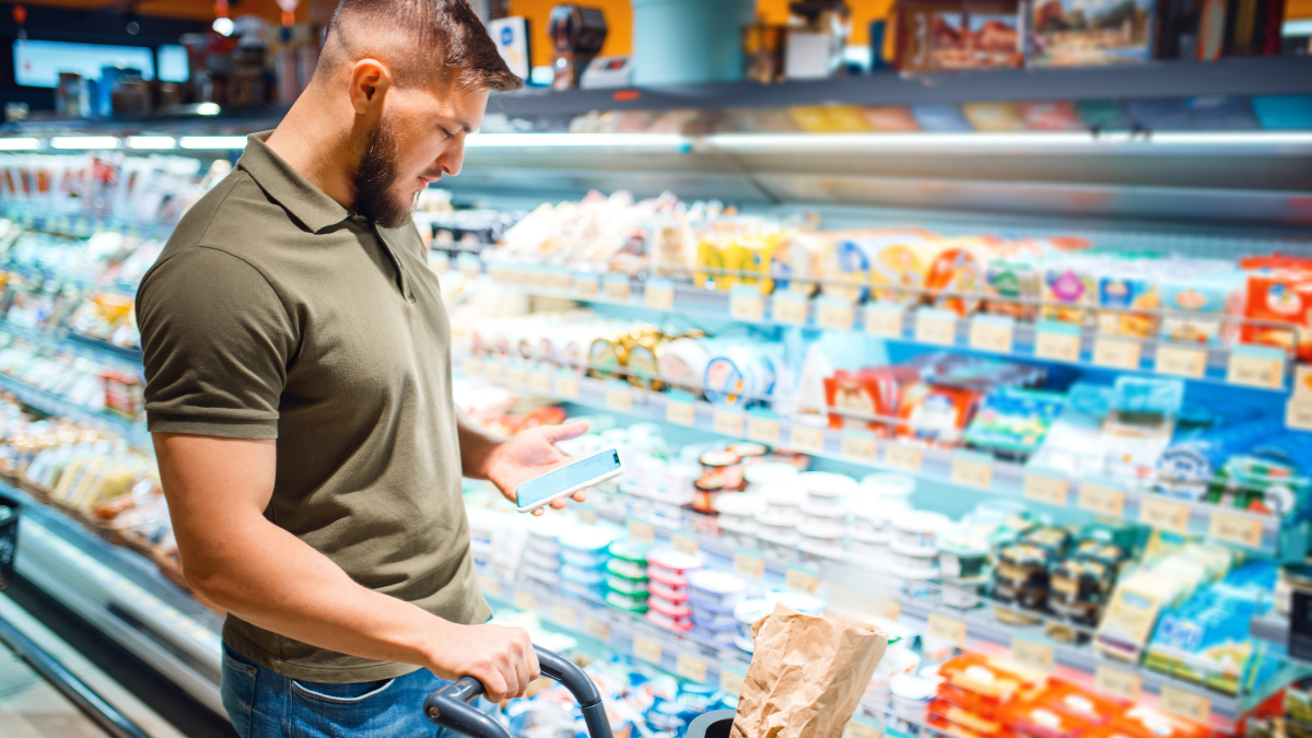 man with shopping cart in grocery store