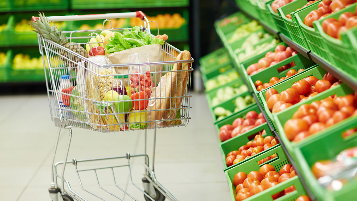 Grocery cart beside produce